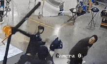 a man is standing in front of a camera that says camera 0 on it