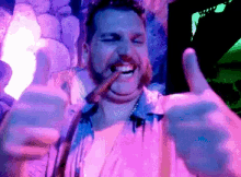 a man is giving a thumbs up while smoking a cigar