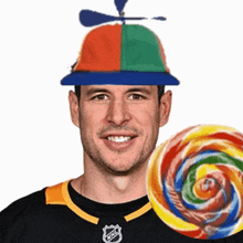 a man wearing a hat with a propeller and a lollipop in front of him