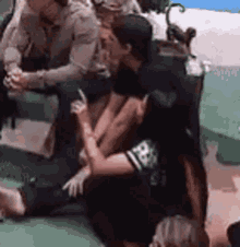 a group of people are sitting on a couch .