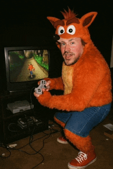 a man dressed in a crash bandicoot costume is playing a video game