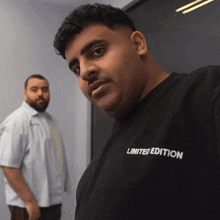 a man wearing a black limited edition t-shirt