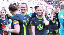 a group of female soccer players wearing jerseys with the number 1 on them