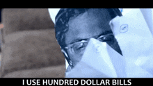 a man wearing a mask with the words " i use hundred dollar bills " below him