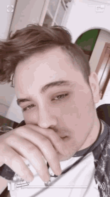 a close up of a man 's face with the letter g in the upper right corner