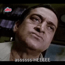 a man is making a funny face and saying assssss-heeee .