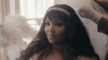 a woman in a wedding dress is getting her hair done by a hairdresser .