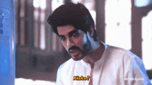 a man with a beard and mustache is talking to someone with the word kisko on his chest