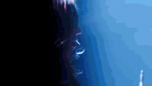 a close up of a person 's face against a dark blue background