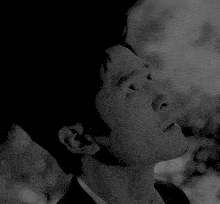 a close up of a man 's face with his eyes closed