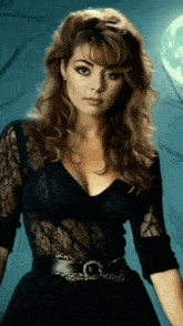 a woman wearing a black lace top and black belt