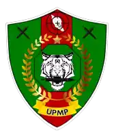 a green shield with a tiger and the word upmp
