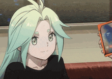 a girl with green hair is holding a cell phone that says ' a ' on it