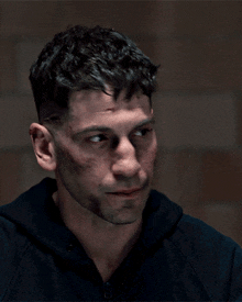 a close up of a man 's face with a scar on his forehead