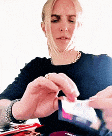 a woman in a black shirt is holding a card that says ' netflix '