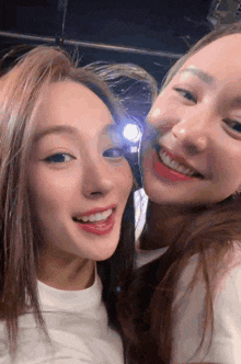 two women are posing for a picture and smiling at the camera