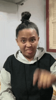 a woman with a bun on her head making a face