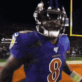 a man in a ravens jersey with the number 8 on his chest