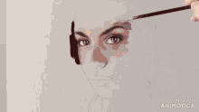 a painting of a woman 's face is being made in animotica