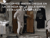 a man is dancing in a room with a sign that says moni coffee ! water !