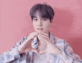 a person is making a heart shape with their hands .