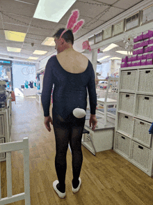 a man in a black leotard with bunny ears on his head
