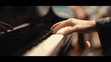 a close up of a person playing a piano with the word kawai on it