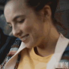a close up of a woman 's face with the words killing eve on the bottom right