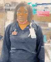 a nurse wearing a mask and a name tag is standing in front of a sign that says personal care .