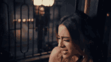 a woman sitting on a balcony looking out the window