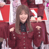 a girl in a red jacket with buttons on the sleeves