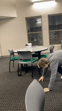 a man is doing push ups in front of a table