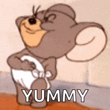a cartoon mouse in a diaper is standing next to a wall and says yummy .