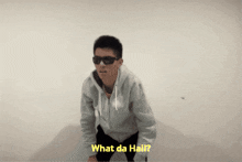 a man wearing sunglasses and a hoodie is asking what da hail