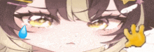 a close up of a girl 's face with a tear coming out of her eye .