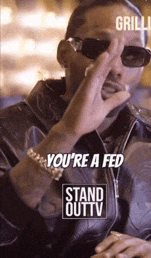 a man wearing sunglasses and a leather jacket says you 're a fed stand out tv