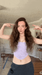 a woman is flexing her muscles in a living room