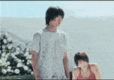 a man and a woman are standing next to each other
