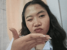 a woman making a funny face with her hand
