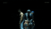a group of men are standing in a dark room with a aew logo in the background .