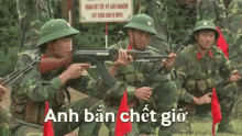 a group of soldiers are sitting in a row holding guns in their hands .