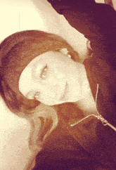 a woman wearing a headband and a black sweatshirt with a zipper