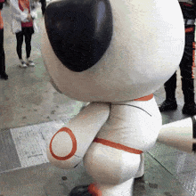 a stuffed animal with a red circle on its leg
