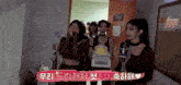 a group of women are standing in a room holding a cake and a trophy .