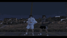 two people dancing in front of a sign that says hollywood