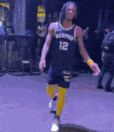 a basketball player wearing a jersey that says memphis 12