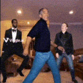 a man in a tuxedo is dancing with two other men in suits