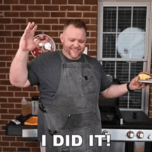 a man wearing an apron is holding a hamburger and says i did it