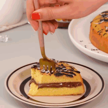a person is holding a fork over a slice of cake