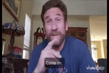 a man with a beard is talking on a video call and says " come on "
